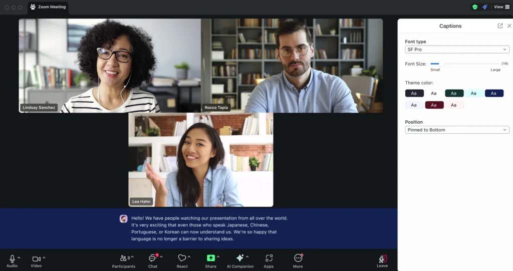 Three participants in a Zoom meeting, showing AI-powered captions at the bottom of the screen and caption personalization settings on the right.